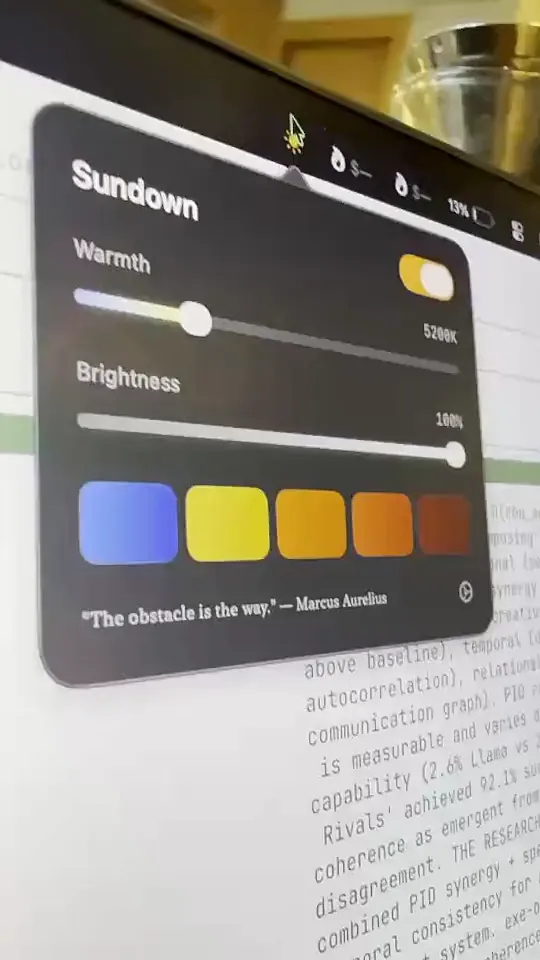 A photo of the Sundown panel open on a MacBook screen, with the Warmth and Brightness sliders and a row of preset colours