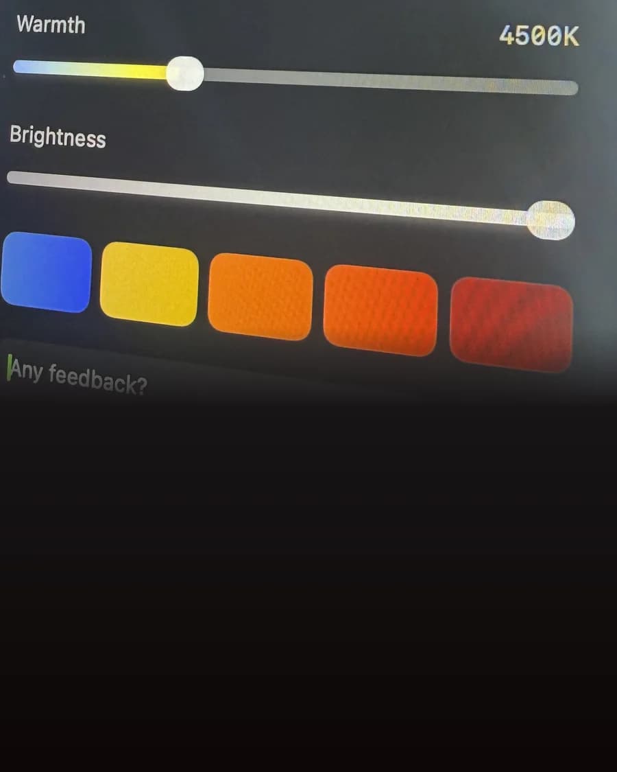 A close photo of the Sundown panel on a Mac screen, showing the Warmth slider and a row of preset colours